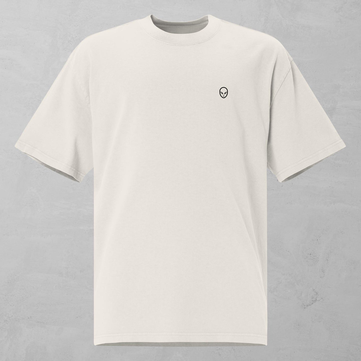 Front view of a faded bone oversized t-shirt featuring a small, alphamonks minimalist logo on the left chest.