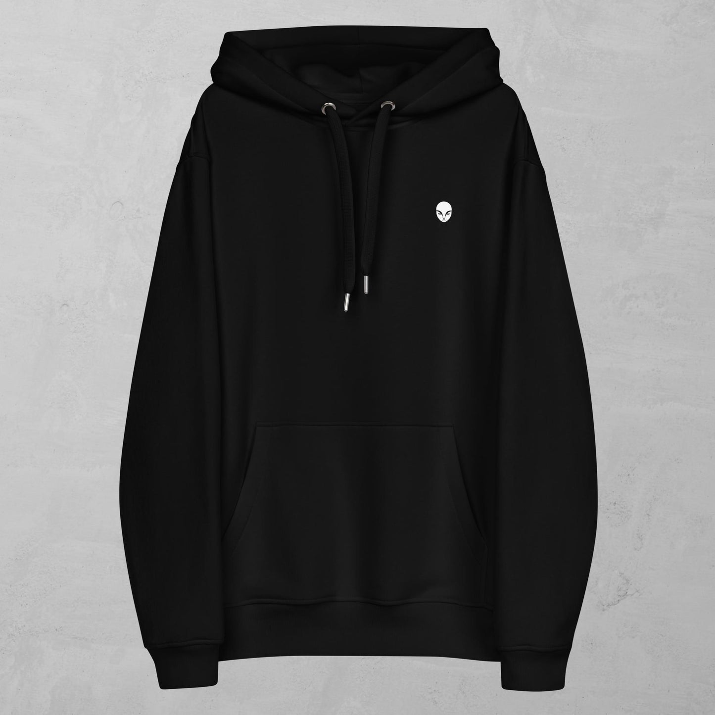 A minimalist black hoodie with a front kangaroo pocket and a simple, small monk head logo on the left chest. The hoodie features metal-tipped drawstrings and a clean, modern design, emphasizing subtlety and elegance. The unisex fit and soft fabric make it suitable for everyday wear, aligning with the Alphamonks brand's focus on combining strength and inner peace.