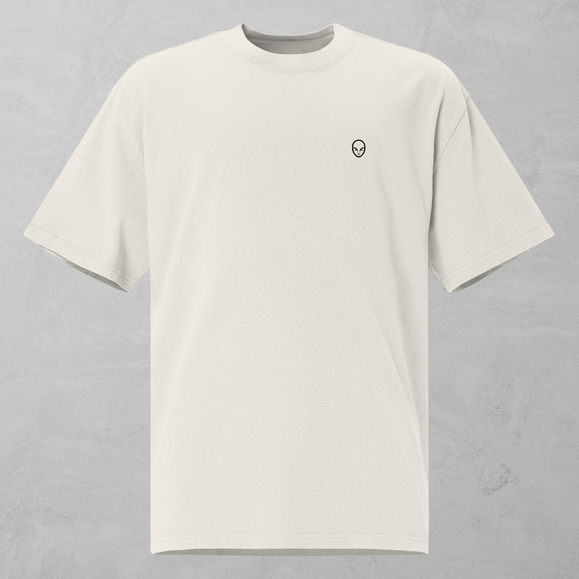 Front view of a faded bone oversized t-shirt featuring a small, alphamonks minimalist logo on the left chest.